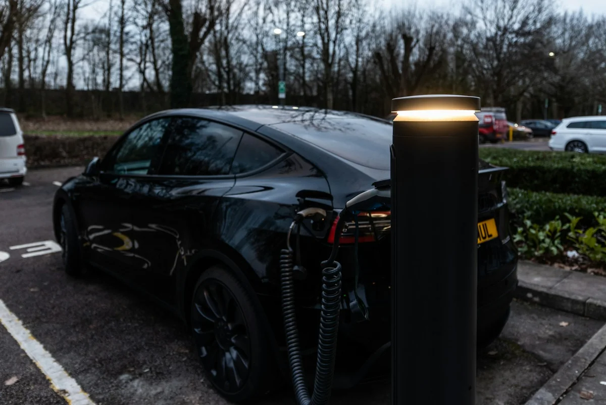 Electric vehicle connected to a wall-mounted charging point