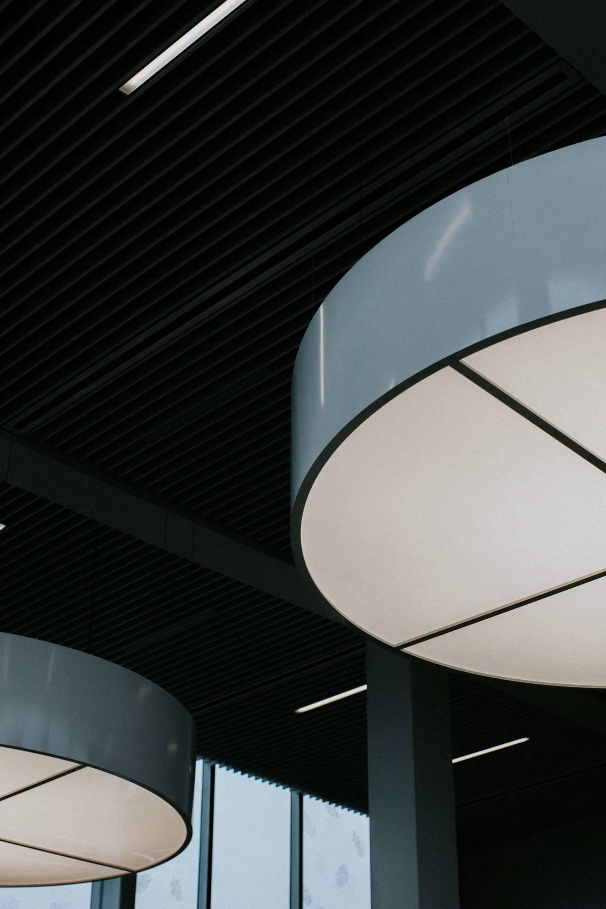 Circular pendant fittings and linear lights in a contemporary commercial interior