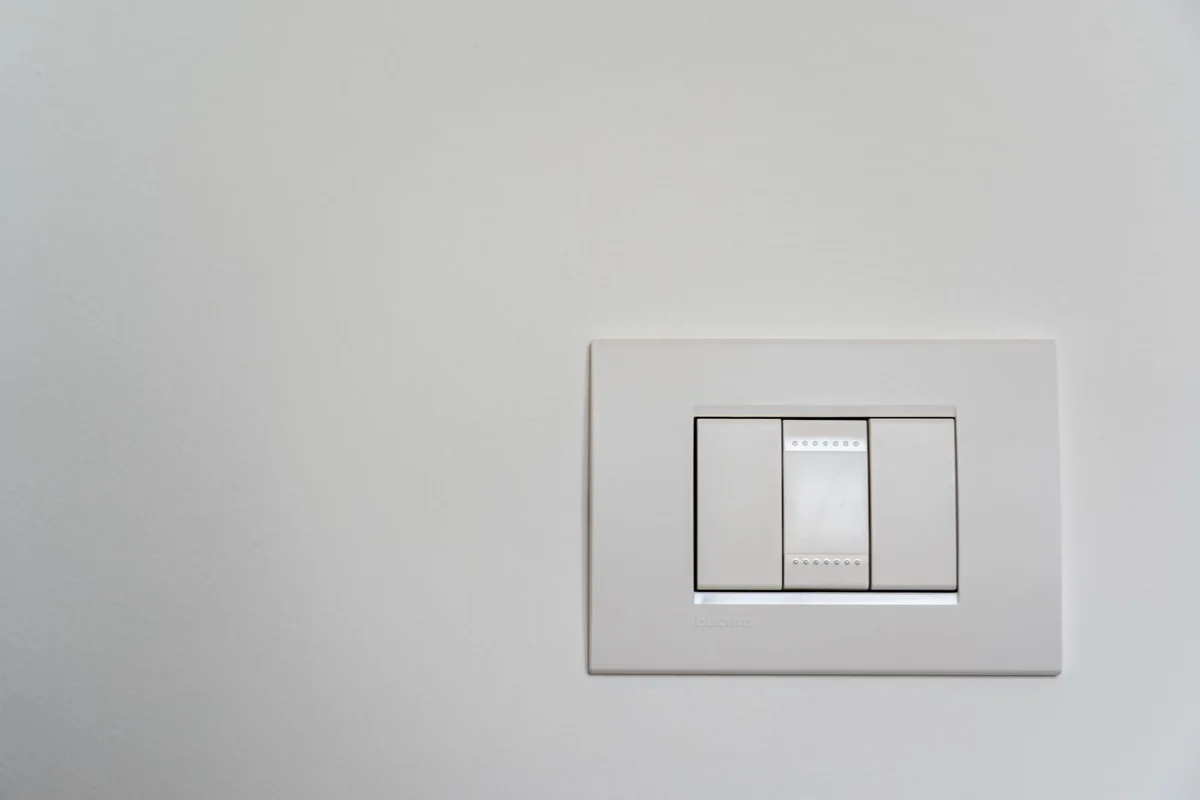 Modern white rocker switch on an interior wall